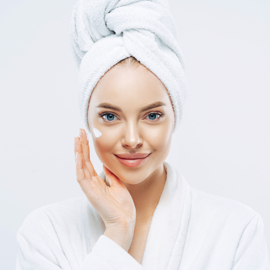 white women applying face cream after bath