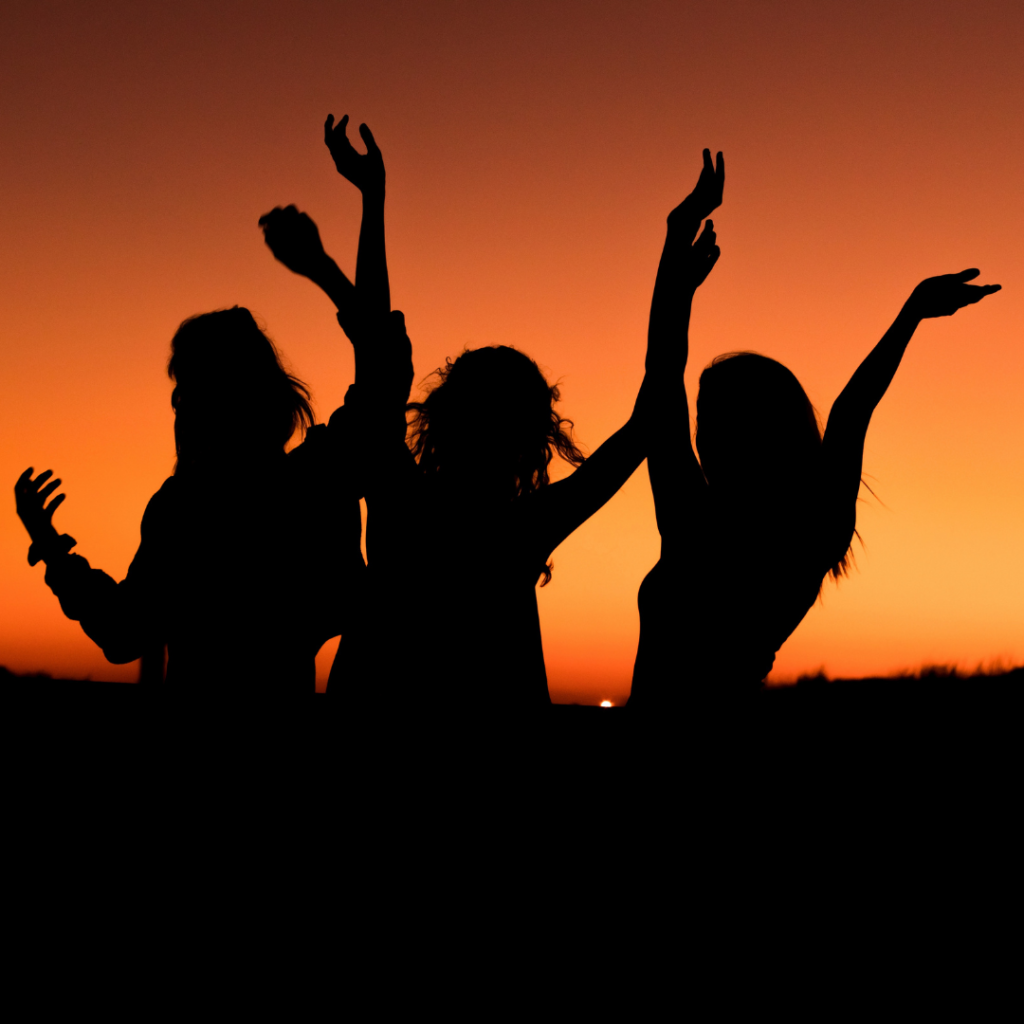 A group of girls enjoying the sunset in the evening 