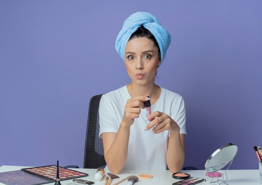 girl removing makeup and accessories on table