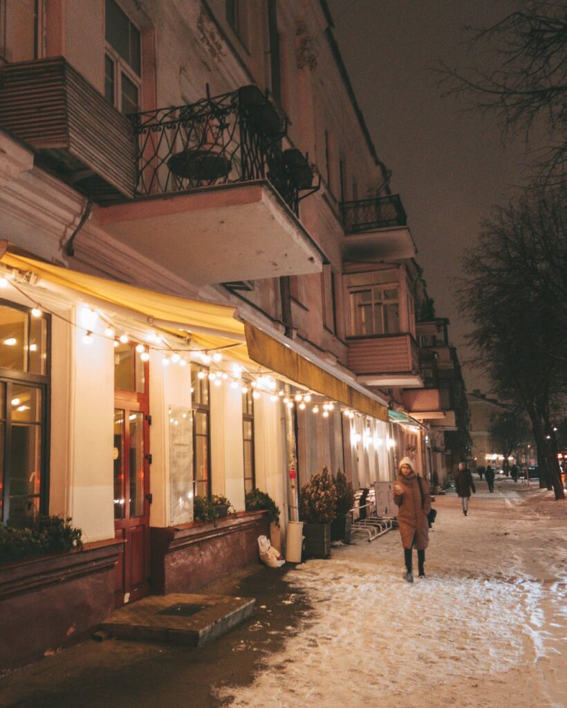 a girl walking on winter evening enjoying cafes
