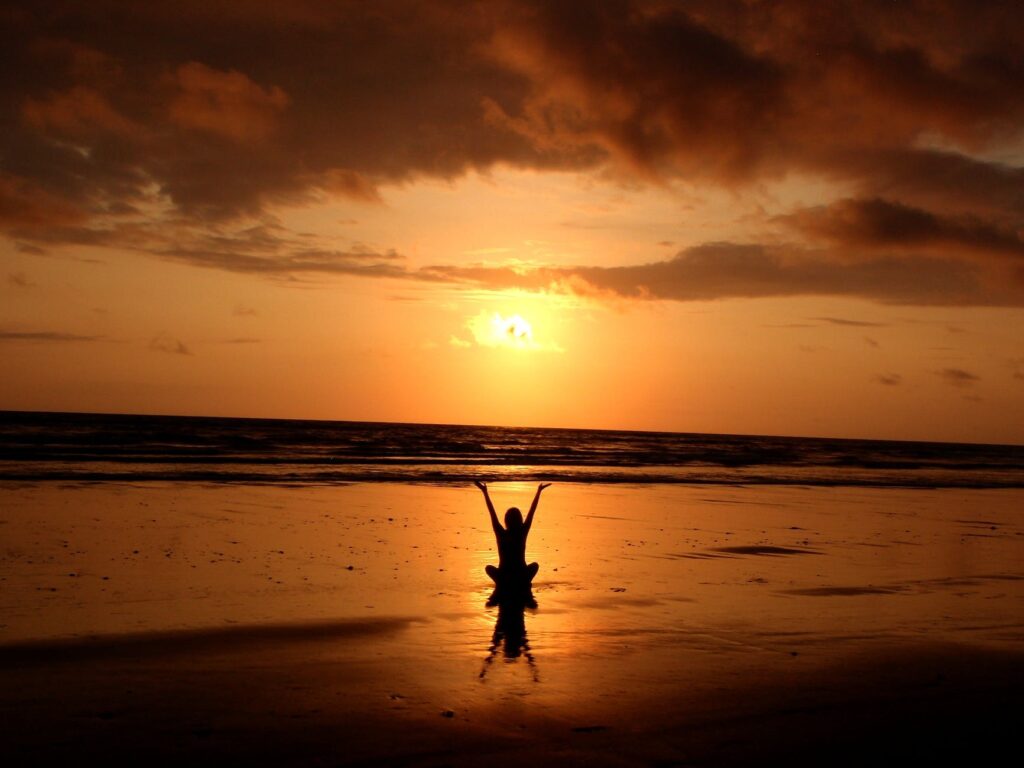silhouette of person raising its hand and doing meditation in order to deal with a complicated situation