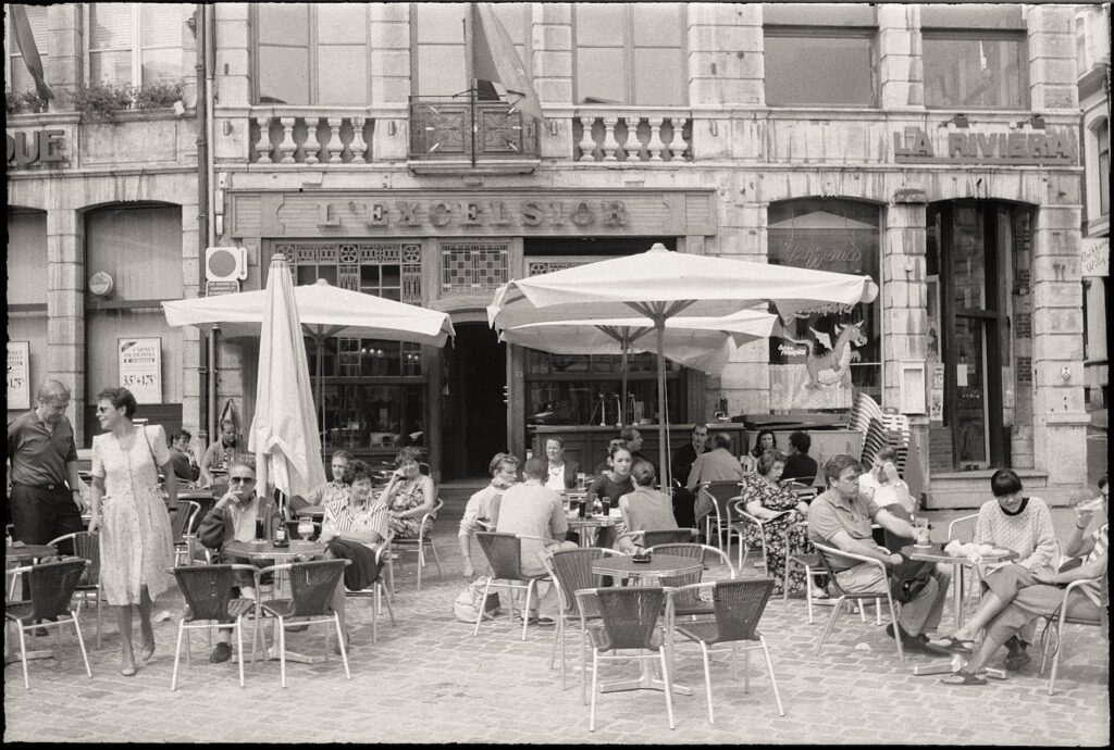 people sitting in sidewalk cafe in Paris